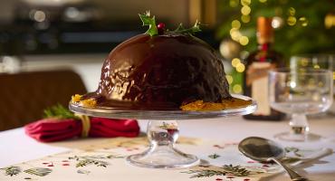 Chocolate Orange Pudding with Chocolate Orange Sauce and a holly decoration