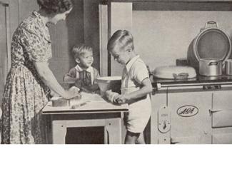 Vintage photo of a family cooking by an AGA